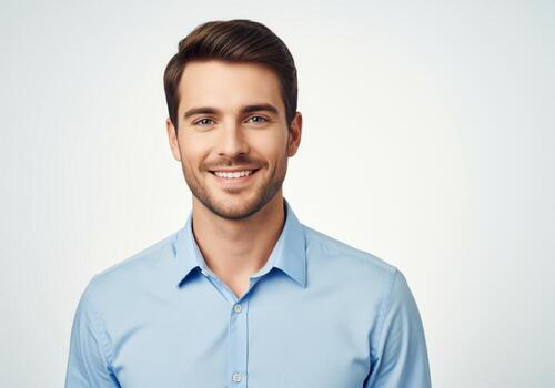 professional-headshot-of-a-handsome-young-man-wearing-a-blue-shirt-and-smiling-photo